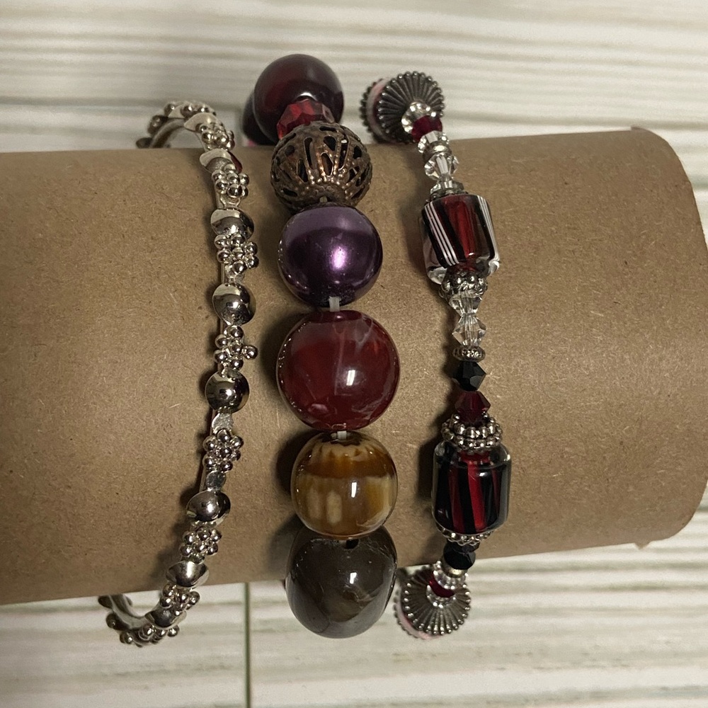 Set of three bracelets, red, pink, purple silver